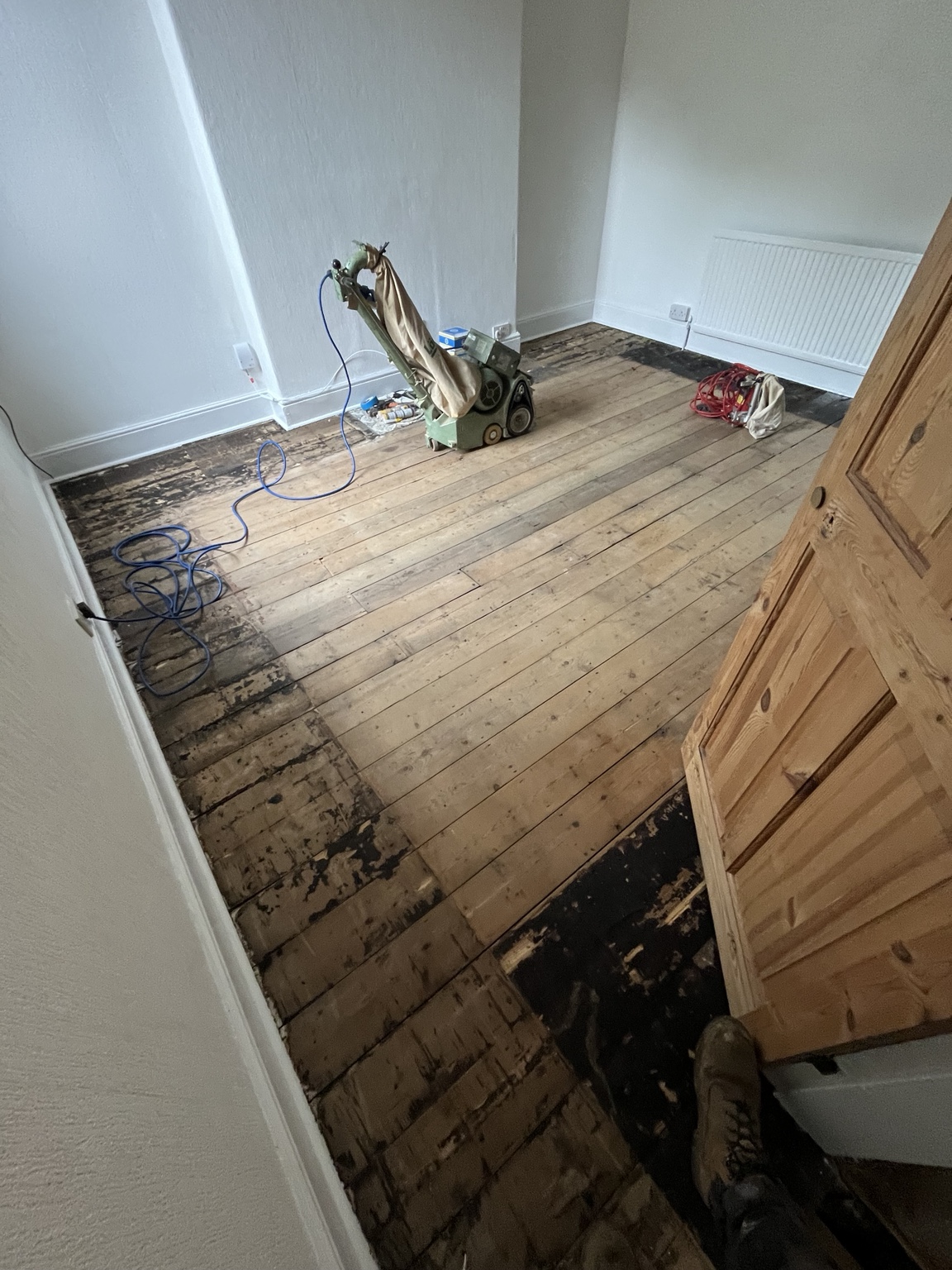 Worn pine floor before restoration